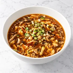 Hot and sour soup with mushrooms, tofu, egg and green onion