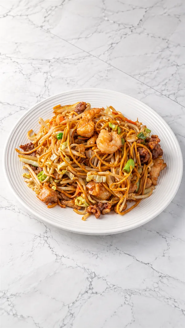 Stir-fried egg noodles with shrimp, beef, chicken and cabbage