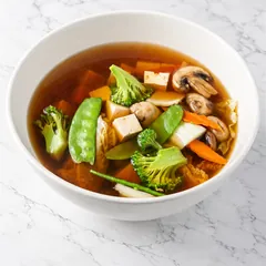 Clear broth with tofu, broccoli, snow peas, carrot, cabbage and mushroom